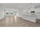 Open-concept kitchen with island, flowing into a bright living area with large windows at 44 Fairwinds Drive Dr, Lillington, NC 27546