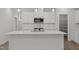 Contemporary kitchen with white cabinetry, stainless steel appliances, and a quartz countertop island at 44 Fairwinds Drive Dr, Lillington, NC 27546