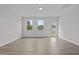 Bright living room featuring stylish gray wood flooring and natural light at 44 Fairwinds Drive Dr, Lillington, NC 27546