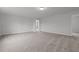 Spacious carpeted living room with overhead lighting and neutral colors at 44 Fairwinds Drive Dr, Lillington, NC 27546