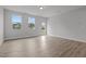 Bright, airy living room with large windows and wood-look floors, creating a welcoming space at 44 Fairwinds Drive Dr, Lillington, NC 27546