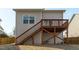 Back of home featuring wood deck with stairs leading to fenced backyard at 4940 Heathshire Dr, Raleigh, NC 27616