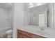Bathroom featuring a single sink, a large mirror, and a shower at 4940 Heathshire Dr, Raleigh, NC 27616