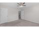 View of bedroom with carpet, ceiling fan, closet and doorways to other rooms at 4940 Heathshire Dr, Raleigh, NC 27616