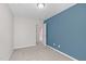 Neutral carpeted bedroom with blue accent wall and white trim throughout at 4940 Heathshire Dr, Raleigh, NC 27616