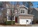 Attractive two-story home featuring stone accents, a two-car garage, and well-maintained landscaping at 4940 Heathshire Dr, Raleigh, NC 27616