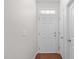 View of front door and foyer with wood floor and coat closet at 4940 Heathshire Dr, Raleigh, NC 27616