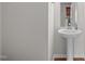 View of half bathroom with pedestal sink and framed mirror at 4940 Heathshire Dr, Raleigh, NC 27616