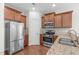 Stylish kitchen boasting stainless steel appliances, granite countertops, and modern cabinets at 4940 Heathshire Dr, Raleigh, NC 27616