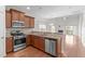Beautiful kitchen with stainless steel appliances, granite countertops, and rich wood cabinetry at 4940 Heathshire Dr, Raleigh, NC 27616