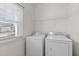 View of laundry room with washer, dryer, and white wire shelf at 4940 Heathshire Dr, Raleigh, NC 27616