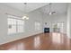 Spacious living room with hardwood floors, vaulted ceiling, fireplace, and sliding doors to the deck at 4940 Heathshire Dr, Raleigh, NC 27616