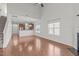 Bright living room featuring hardwood floors, a fireplace, and an open layout to the kitchen at 4940 Heathshire Dr, Raleigh, NC 27616