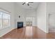 Bright living room with a fireplace, hardwood floors, vaulted ceilings, and access to outdoor space at 4940 Heathshire Dr, Raleigh, NC 27616