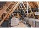 Unfinished attic area featuring beams, insulation, and a white bean bag chair at 50 Sneed Ln, Fuquay Varina, NC 27526