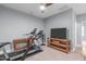 Finished basement area with a treadmill, exercise bike, and a flat screen TV at 50 Sneed Ln, Fuquay Varina, NC 27526