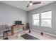 Finished basement featuring exercise equipment, a desk, and two windows at 50 Sneed Ln, Fuquay Varina, NC 27526
