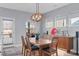 Dining room featuring a wooden dining set, modern light fixture, and access to the backyard at 50 Sneed Ln, Fuquay Varina, NC 27526