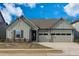 Charming home featuring a three car garage, stone accents, a well kept lawn, and board and batten siding at 50 Sneed Ln, Fuquay Varina, NC 27526