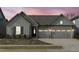 Charming home featuring a three car garage, stone accents, a well kept lawn, and board and batten siding at 50 Sneed Ln, Fuquay Varina, NC 27526