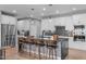 An open-concept kitchen boasts an island with barstool seating, stainless steel appliances, and sleek marble countertops at 50 Sneed Ln, Fuquay Varina, NC 27526