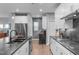 Modern kitchen with gray marble countertops, bright white cabinets, and stainless steel appliances at 50 Sneed Ln, Fuquay Varina, NC 27526