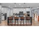 An open-concept kitchen boasts an island with barstool seating, stainless steel appliances, and sleek marble countertops at 50 Sneed Ln, Fuquay Varina, NC 27526