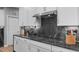 Modern kitchen featuring bright white cabinets, gray marble countertops, and a stainless steel range hood at 50 Sneed Ln, Fuquay Varina, NC 27526