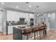 An open-concept kitchen boasts an island with barstool seating, stainless steel appliances, and sleek marble countertops at 50 Sneed Ln, Fuquay Varina, NC 27526