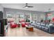 Bright living room with hardwood floors, a ceiling fan, red leather chairs, and great natural light at 50 Sneed Ln, Fuquay Varina, NC 27526