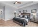 Well-lit main bedroom features a neutral palette, tray ceiling, and calming decor at 50 Sneed Ln, Fuquay Varina, NC 27526