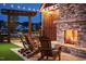Outdoor fireplace and seating area with wood-burning fireplace, and string lights overhead at 50 Sneed Ln, Fuquay Varina, NC 27526