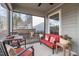 Screened patio featuring a red outdoor couch set and an outdoor dining table at 50 Sneed Ln, Fuquay Varina, NC 27526