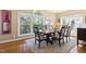 Elegant dining room with a large table, ample natural light from surrounding windows, and hardwood flooring at 50002 Brogden, Chapel Hill, NC 27517