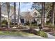 Charming home featuring a landscaped front yard, gray shingles, stone accents, and mature trees at 50002 Brogden, Chapel Hill, NC 27517