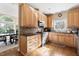 Well-lit kitchen featuring wooden cabinets, granite countertops, and stainless steel appliances at 50002 Brogden, Chapel Hill, NC 27517