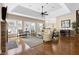 Bright living room featuring hardwood floors, a stone fireplace, and large windows for ample natural light at 50002 Brogden, Chapel Hill, NC 27517