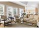 Bright living room showcasing a neutral color palette, large windows, and comfortable seating arrangements at 50002 Brogden, Chapel Hill, NC 27517