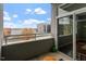 Balcony view with outdoor seating overlooking city buildings at 506 N Mangum St # 303, Durham, NC 27701