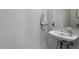 A bathroom with a pedestal sink and modern faucet, complemented by a sleek mirror at 506 N Mangum St # 303, Durham, NC 27701