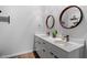 Modern bathroom features double vanity with sleek countertop and round mirrors at 506 N Mangum St # 303, Durham, NC 27701