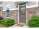 Inviting front door with a 'Welcome' mat and manicured landscaping enhancing curb appeal at 510 Berry Chase Way, Cary, NC 27519