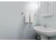 Clean half bathroom with a pedestal sink and white towels providing a minimalist design at 510 Berry Chase Way, Cary, NC 27519