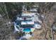 Overhead shot of a Gathering home with private pool, deck, and snow-covered roof surrounded by lush greenery at 515 S Woodland Rd, Henderson, NC 27536