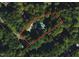 Aerial view showing property lines, a house, and a pool surrounded by trees at 515 S Woodland Rd, Henderson, NC 27536