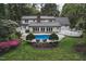 Back of house with in-ground swimming pool, patio and landscaped yard at 515 S Woodland Rd, Henderson, NC 27536