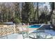 Spacious backyard featuring a pool and lush greenery; ideal for relaxation at 515 S Woodland Rd, Henderson, NC 27536