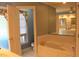 Luxurious bathroom with a soaking tub, elegant fixtures, and a large mirror at 515 S Woodland Rd, Henderson, NC 27536