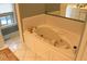 Bright bathroom showcasing a large, tiled bathtub and gold-toned fixtures at 515 S Woodland Rd, Henderson, NC 27536