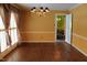 Bright dining room with hardwood floors, chandelier, and natural light through large shuttered windows at 515 S Woodland Rd, Henderson, NC 27536